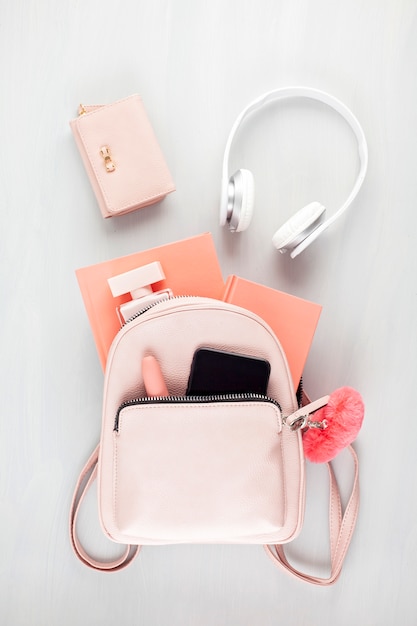 Flat lay with girls spring summer accessories in pink pastel tones. Casual urban summer style, shopping concept
