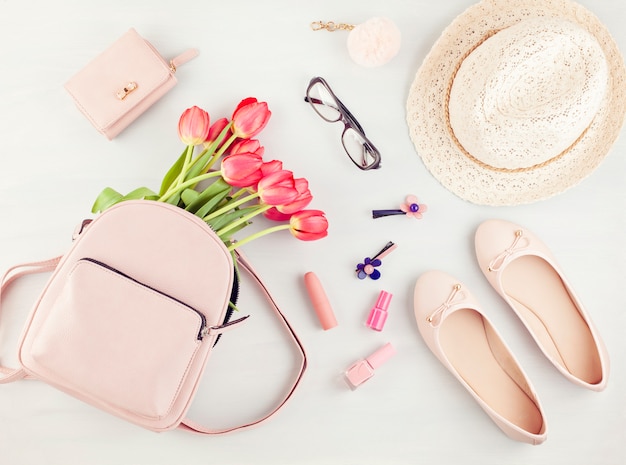 Flat lay with girls spring summer accessories in pink pastel tones.