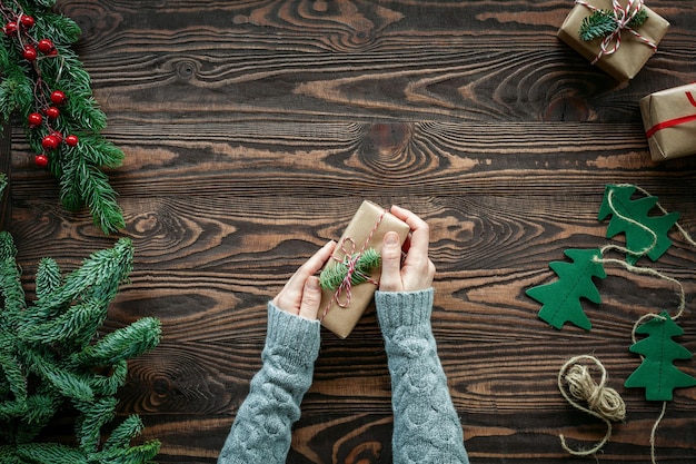 Flat lay with hands holding a Christmas gift