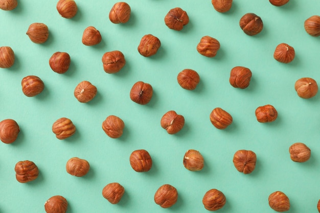 Flat lay with hazelnuts on mint background