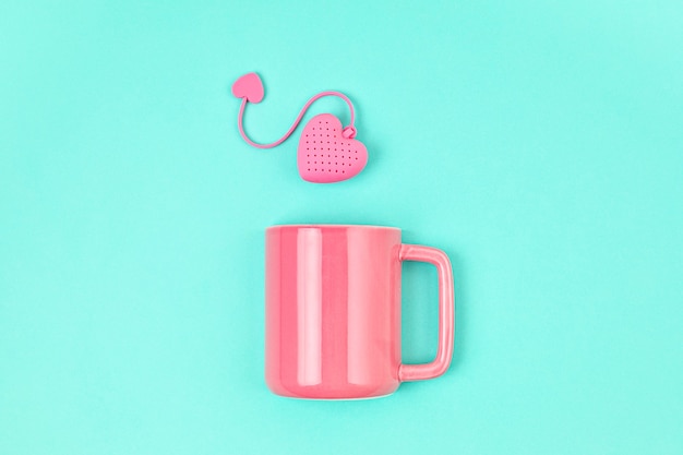 Flat lay with heart shaped tea bag and cup. Waking up, morning tea, every day rituals, zen attitude, destress, healthy drink, love concept