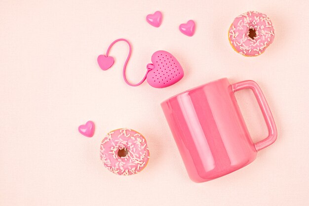 Flat lay with heart shaped tea bag, donuts and cup. Waking up, morning tea, every day rituals, zen attitude, destress, healthy drink, love concept