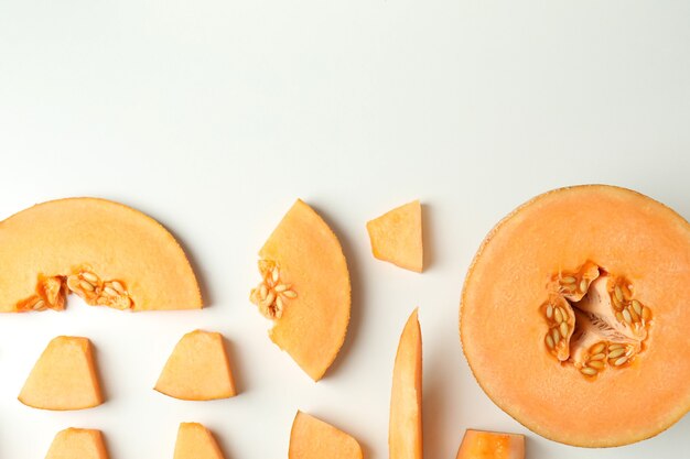 Flat lay with melon slices on white background