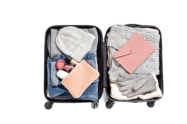 Flat lay with open suitcase with casual clothes