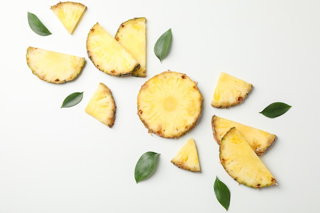 Photo flat lay with pineapple slices on white background, space for text