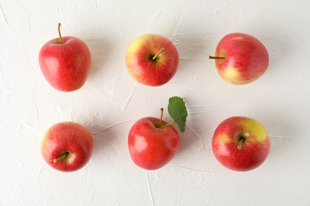 Flat lay with red apples on white table