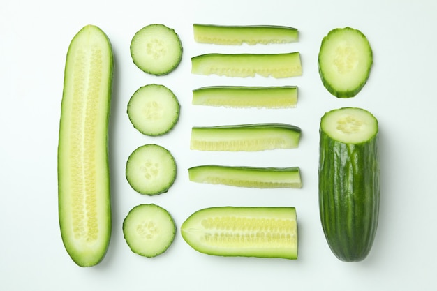 Flat lay with ripe cucumbers on white background