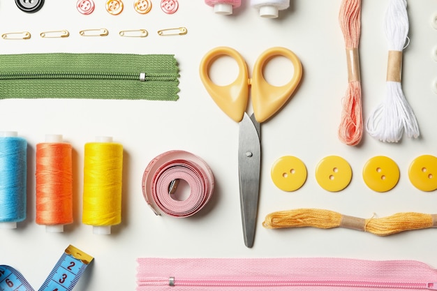 Flat lay with sewing supplies on white