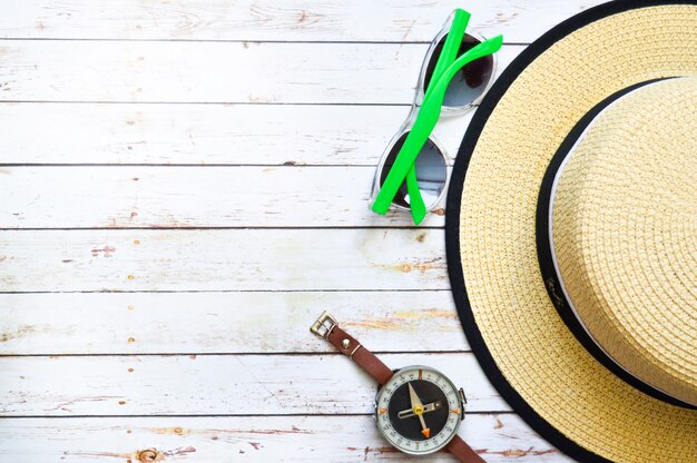 Flat lay with straw hat, sunglasses, compass and starfish 