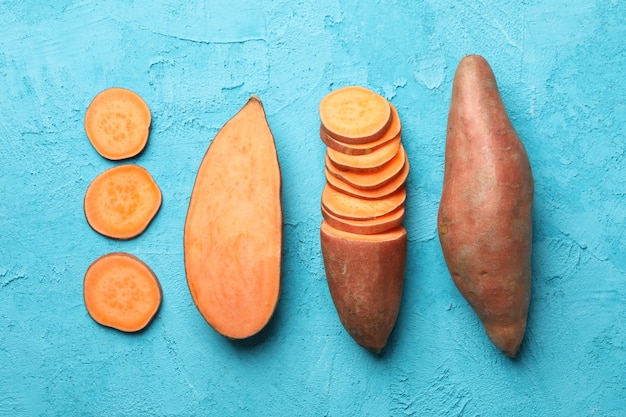 Flat lay with Sweet potatoes on blue surface