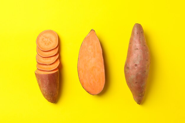 Flat lay with Sweet potatoes on yellow surface