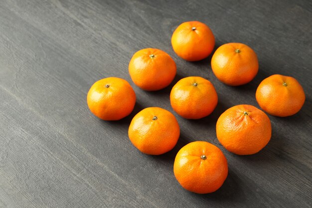 Flat lay with tasty mandarins on textured wooden table