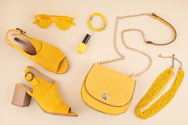 Flat lay with woman fashion accessories in yellow and blue colors. Fashion blog, summer style, shopping and trends concept