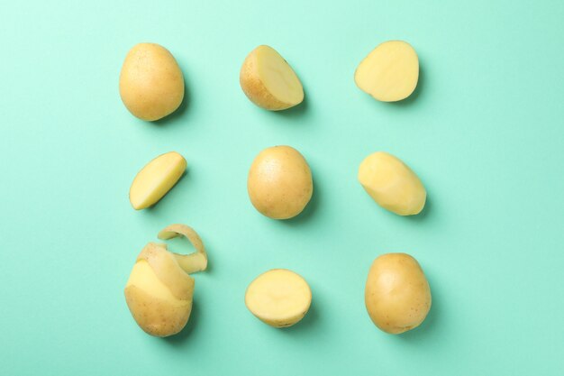 Flat lay with young potatoes on mint surface