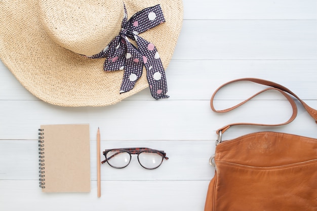 Flat lay of woman accessories on vintage wooden background