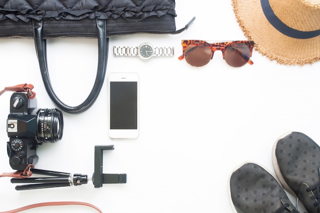 Flat lay of woman accessories with cellphone film camera and black color items on white background, Lifestyle concept, Top view