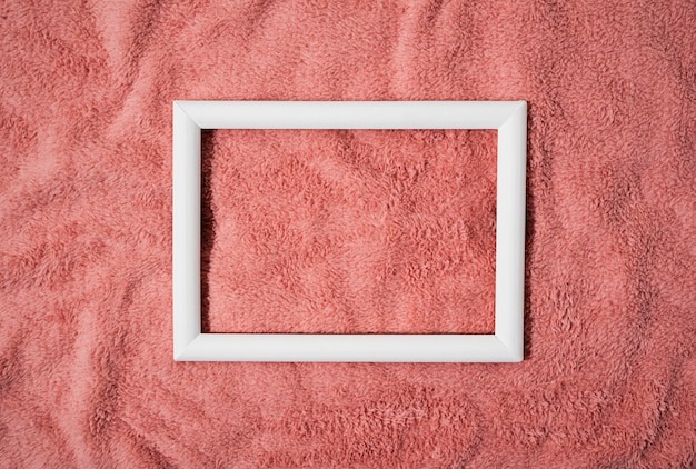 Flat lay wooden frame on pink blanket