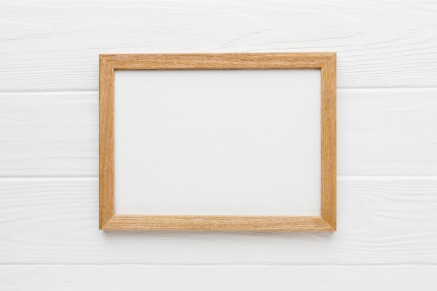 Photo flat lay of wooden frame with copy space