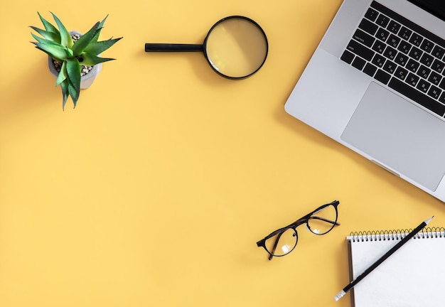 Flat lay workplace minimalism yellow background copy space