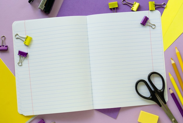 Flat lay of yellow and lilac school supplies