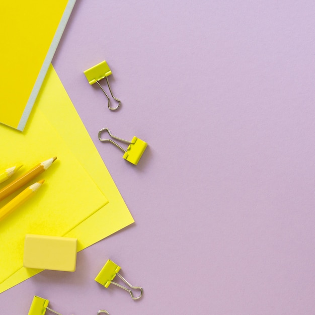 Flat lay of yellow and lilac school supplies