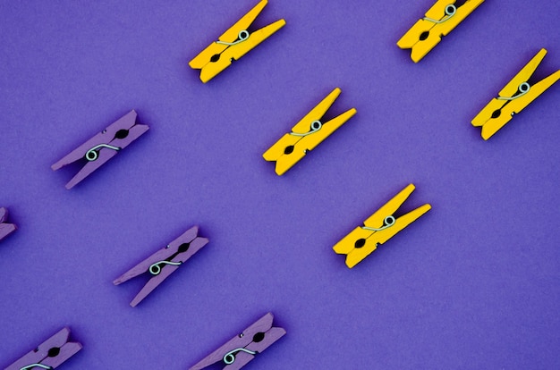 Flat-lay yellow and purple clothes pins 