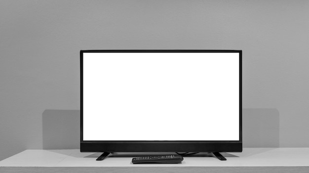 Flat lcd television on wood table in the living room with dark\
gray wall