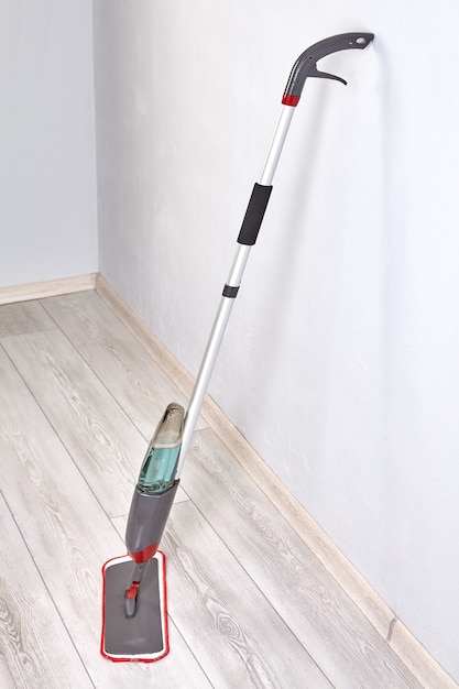 Flat spray mop for water spraying floor cleaner with trigger spray on handle and microfiber pad