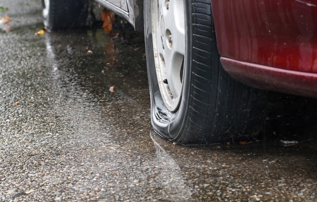 Flat tire car in rainy day on streetxA