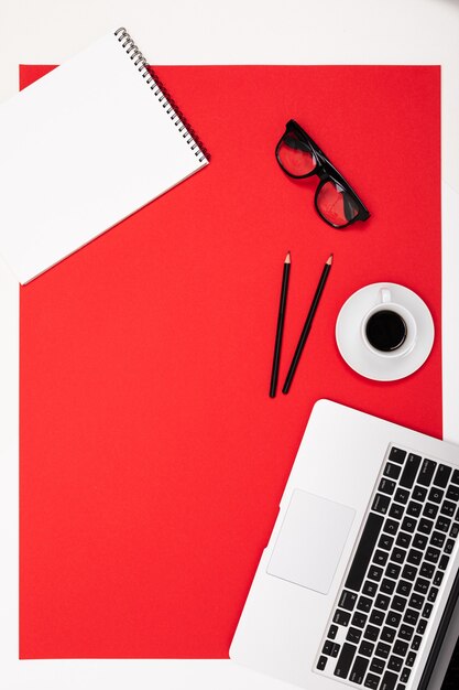 Flat view of the office desk with a creative arrangement of stationery and notebooks for the desktop.