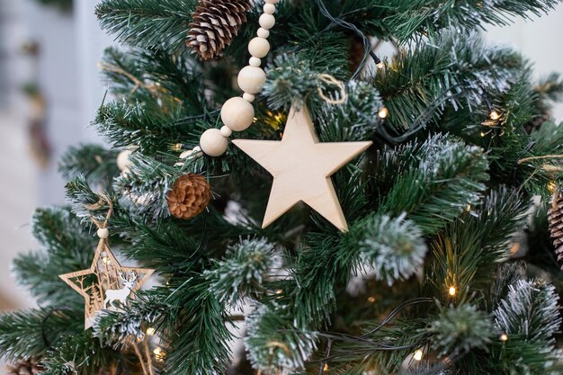 Flat wooden star shaped decoration hanging on christmas tree