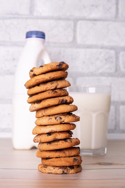 Flatlay an after school snack of chocolate chip cookies and an glass cup of milk bottle of milk