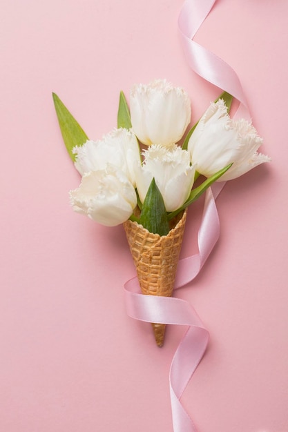 Flatlay waffle cone with white flower blossom