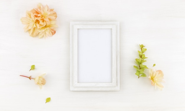 Flatlay wooden frame  with flowers