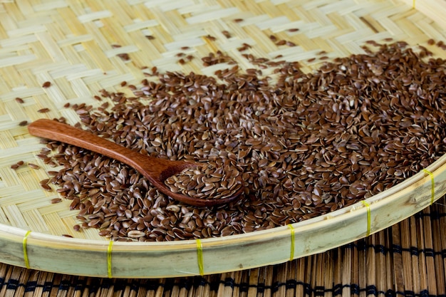 flax seed with spoon placed on flat woven basket