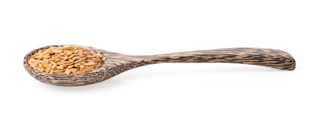 Flax seed in wood spoon on white background