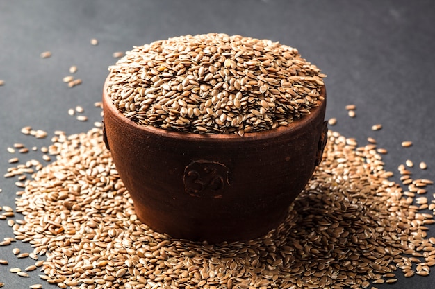 Flax seeds on a black background. 