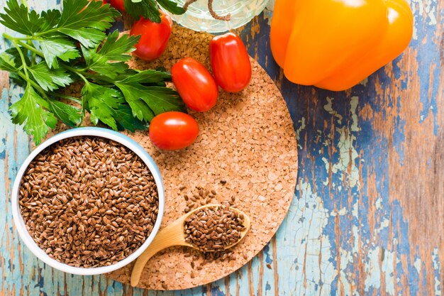 Flax seeds in a bowl on a wooden table