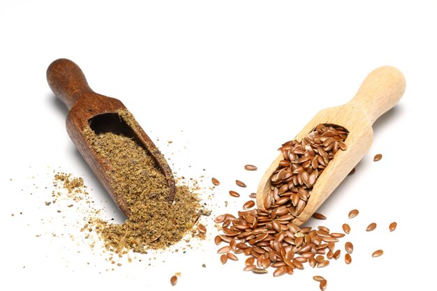 Flax seeds Flaxseed powder in a wooden spoon Standing on a white background