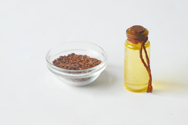 Flax seeds and oils in a jar on white background