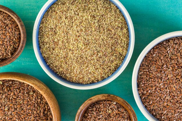 Flax seeds on painted wood board.