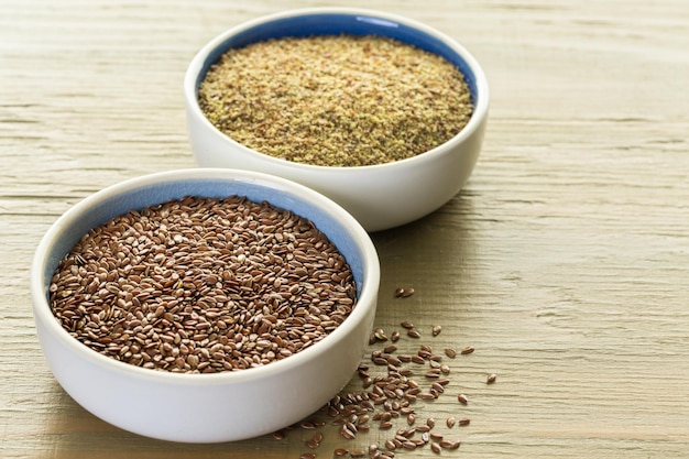 Flax seeds on painted wood board.