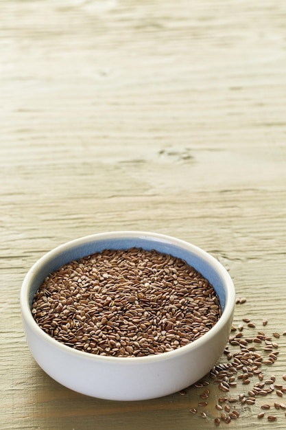 Flax seeds on painted wood board.