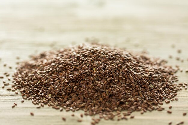 Flax seeds on painted wood board.