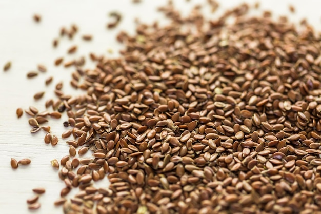 Flax seeds on painted wood board.