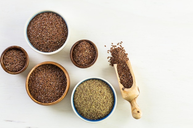 Flax seeds on painted wood board.