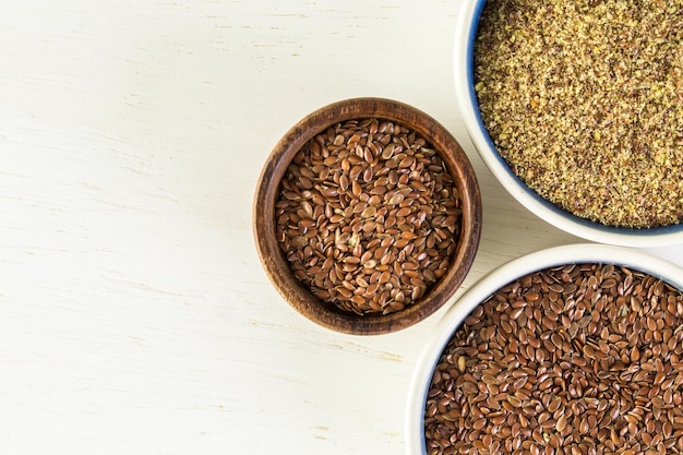 Flax seeds on painted wood board.