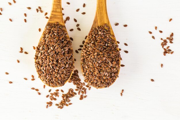 Flax seeds on painted wood board.