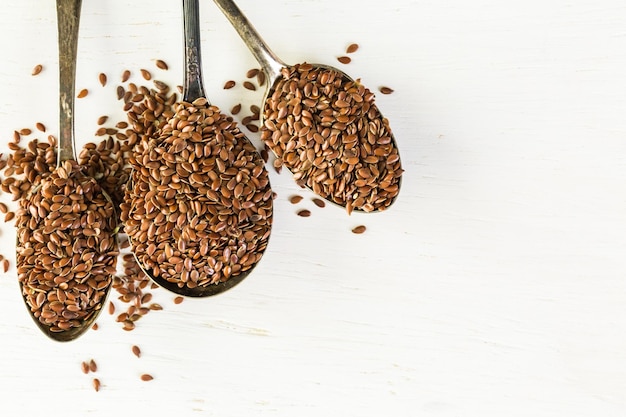 Flax seeds on painted wood board.