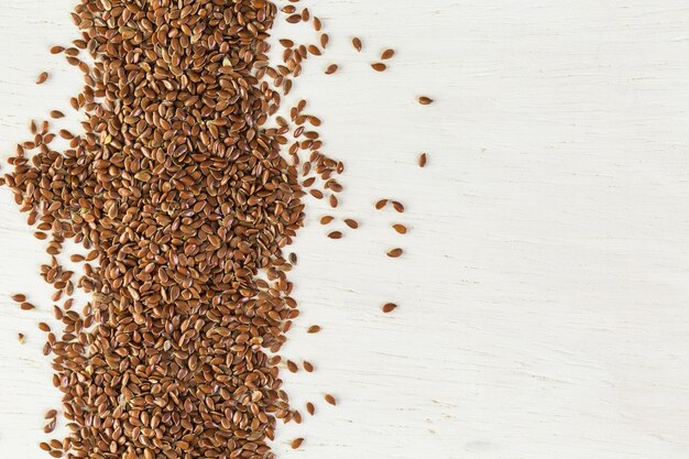 Flax seeds on painted wood board.